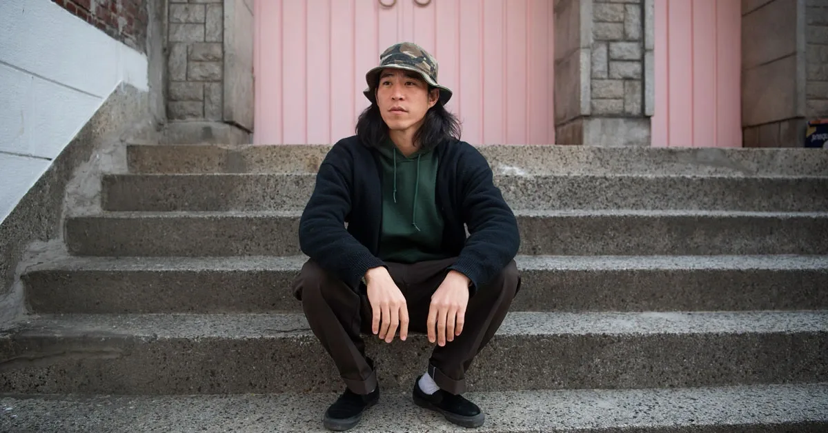 man wearing dark clothes sitting on the steps