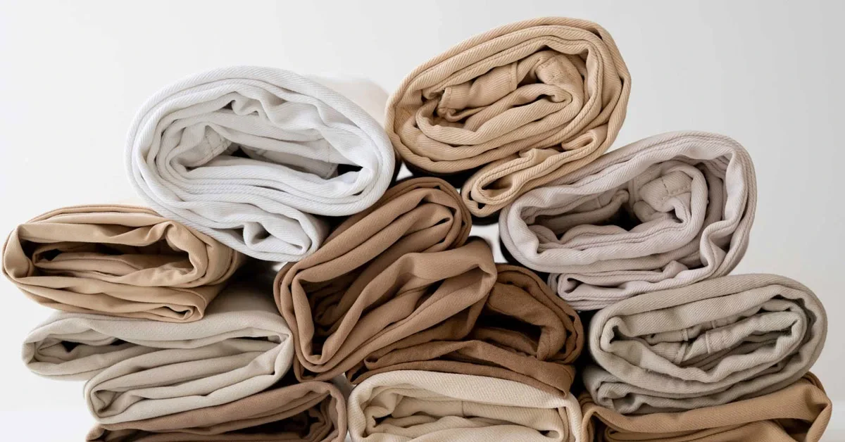 pairs of rolled light colored denim jeans